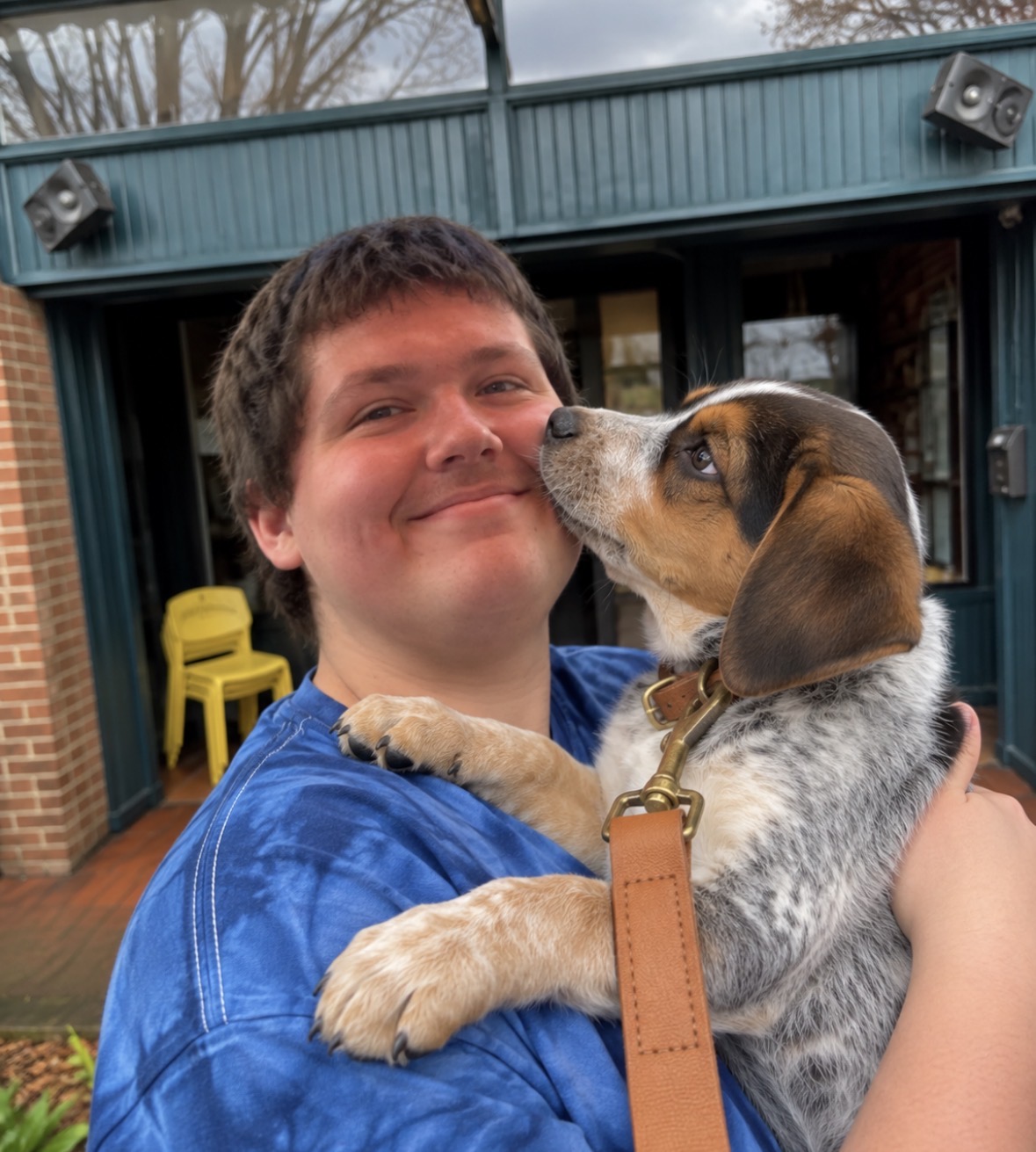 A young man sharing a warm moment with a rescue puppy