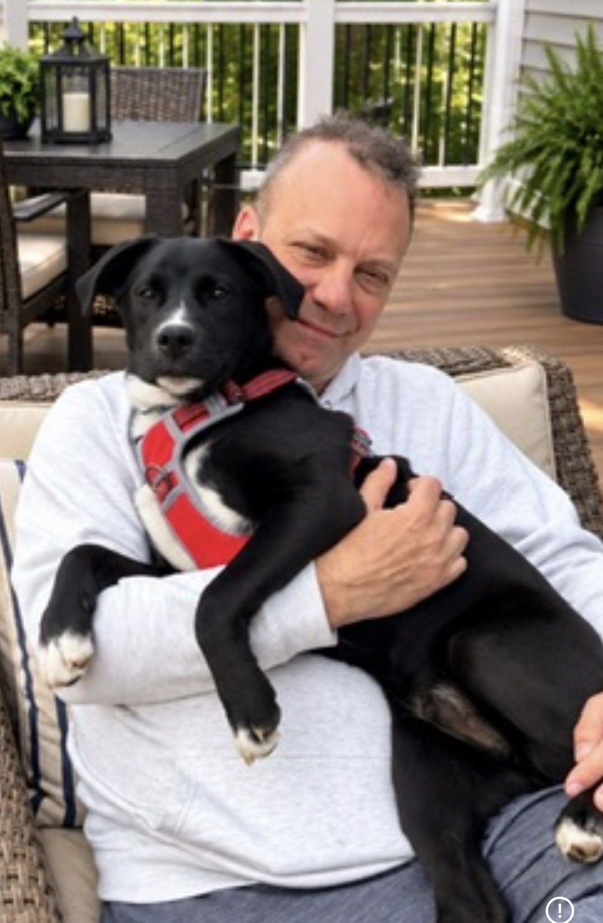 A rescue volunteer cuddling a dog
