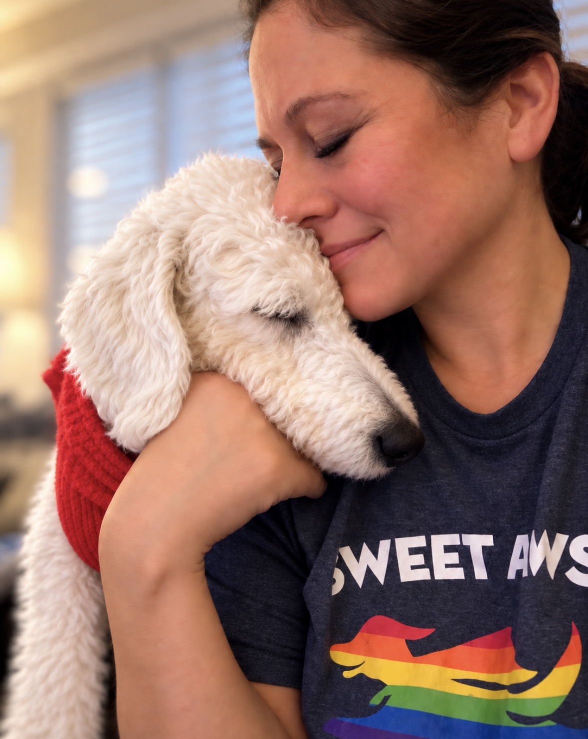 Karen cuddling a white rescue puppy